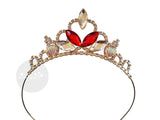 A gold tiara headband adorned with red marquise-cut crystals, clear teardrop crystals, and iridescent scallop crystals on a white background.